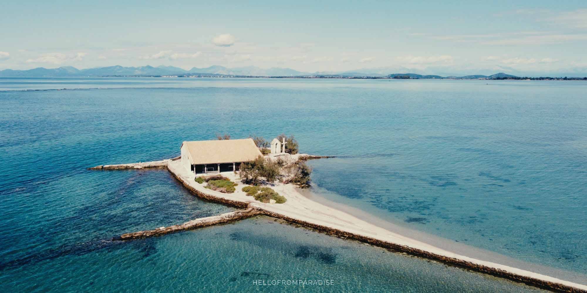 A church built on an islet surrounded by turquoise sea in Greece