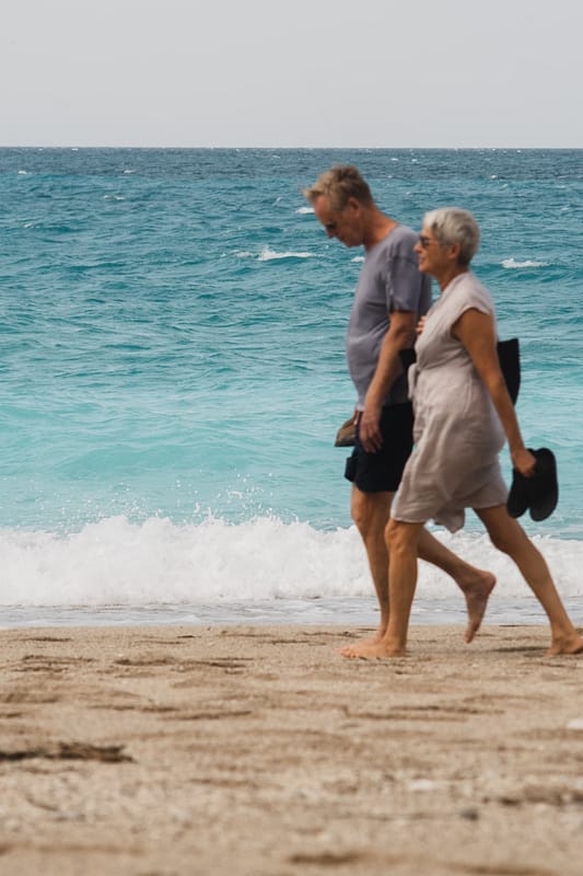 mature people walking on the beach
