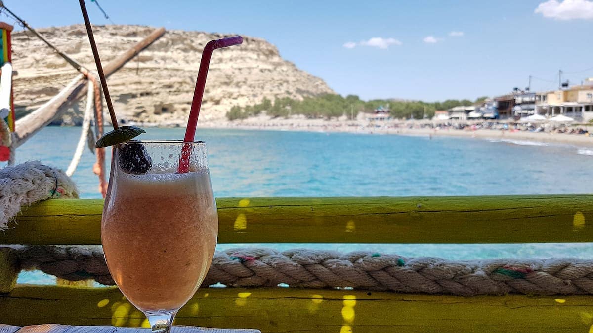 Cocktail at a bar with a view to Matala Beach