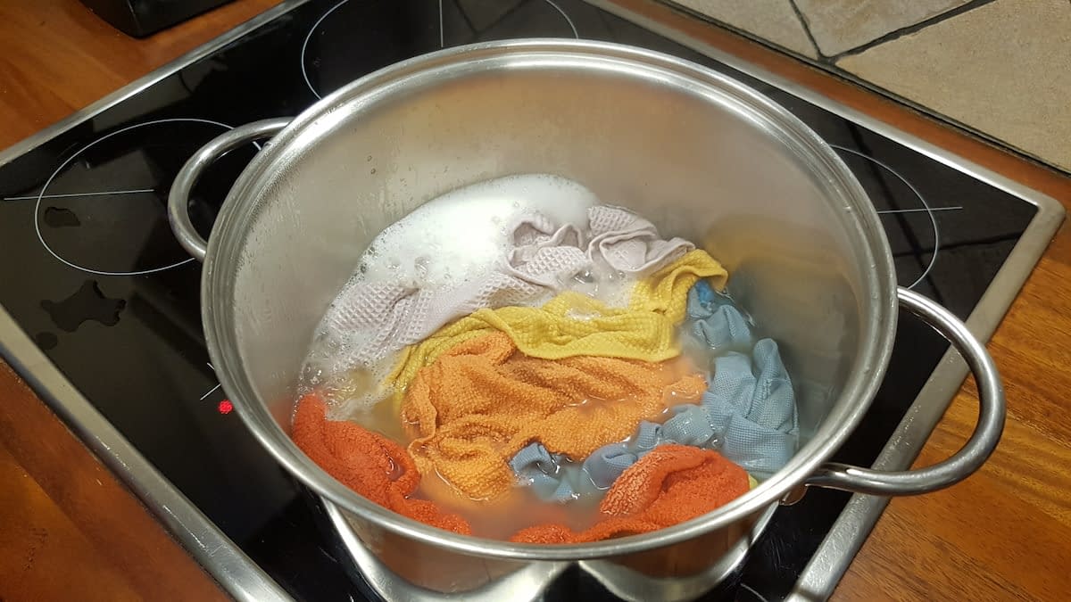 boiling kitchen cloths not only kills all microbes and bacteria but also gets red of the specific old cloth stink