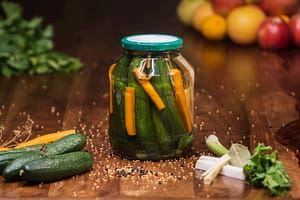 Jar of homemade sweet and sour pickled cucumbers. An old family recipe for pickling beginners.